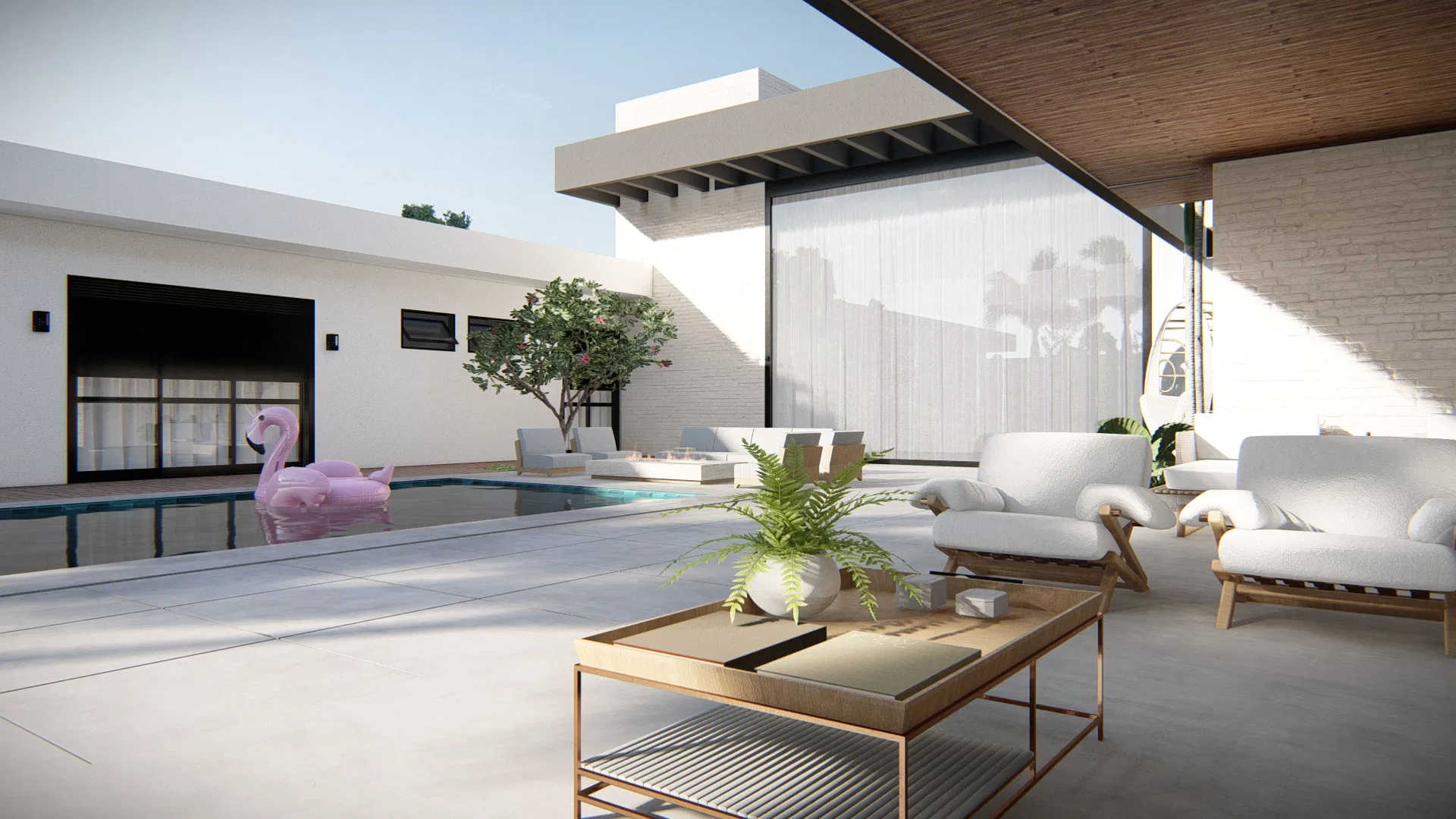 Covered outdoor lounge with white armchairs and a brass table, facing the pool with a pink flamingo float and sheer curtains.