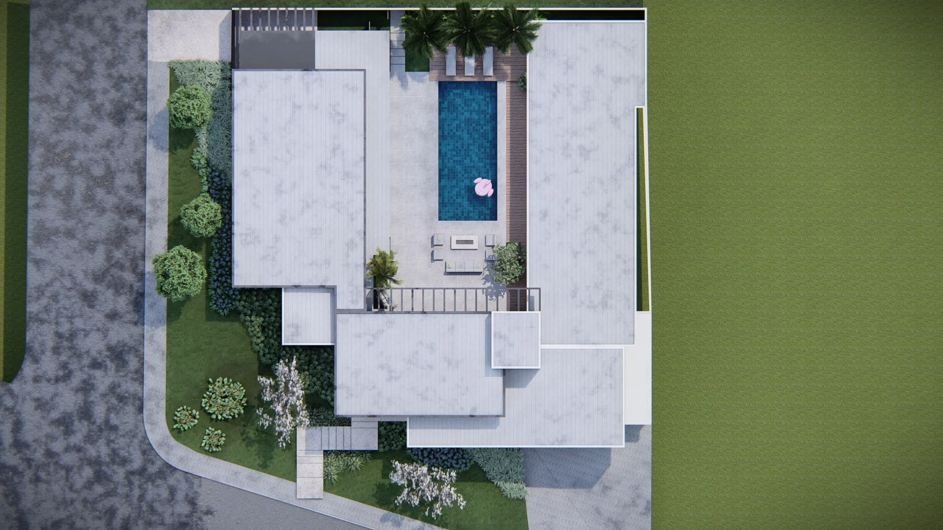 Aerial view of the plot showing the pool with a flamingo float, wood deck, rooflines and surrounding landscaping.